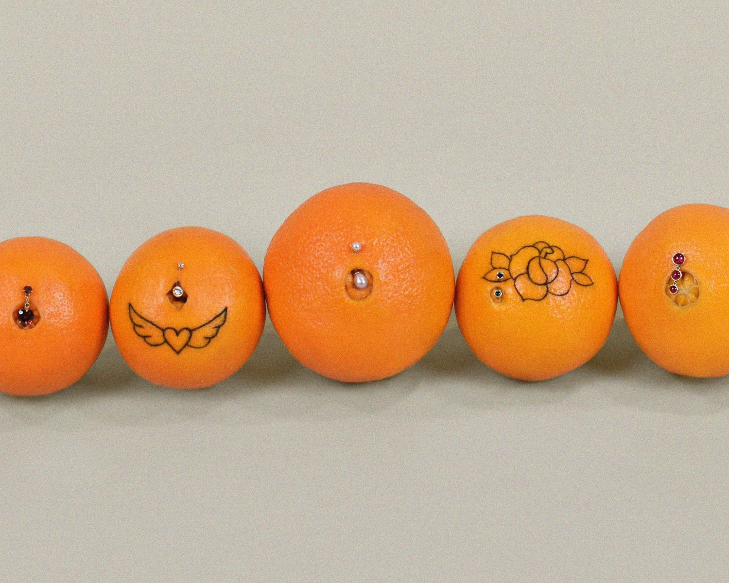 collection of navel oranges wearing navel rings